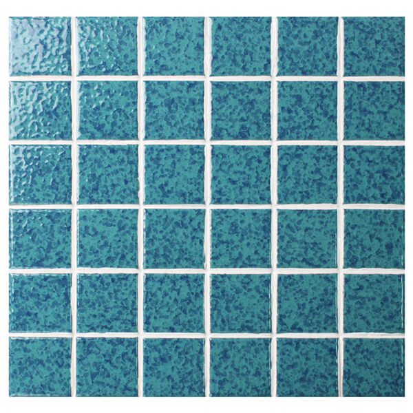cut turquoise pool tile sheet to have chips and decorate pool step.jpg