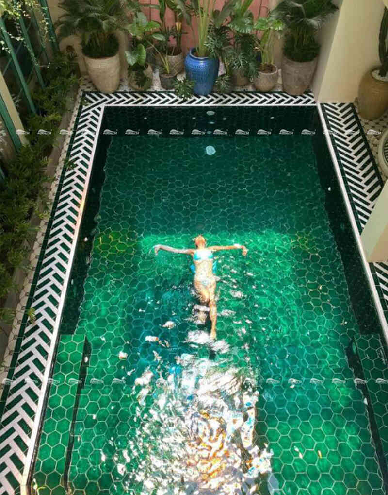 green swimming pool with porcelain pool tiles
