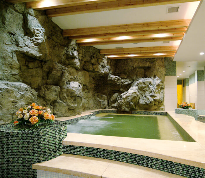 shallow indoor landscape pool decorated with green glass tile mosaics.jpg