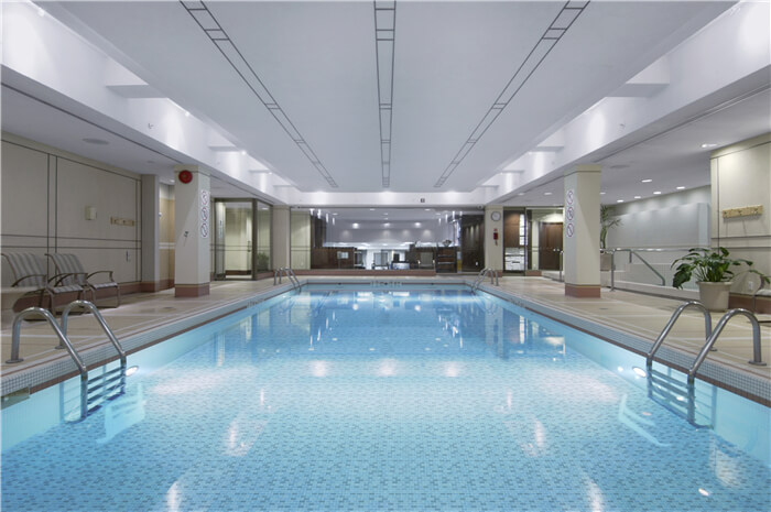 indoor regular pool decorated with light blue pool tiles.jpg