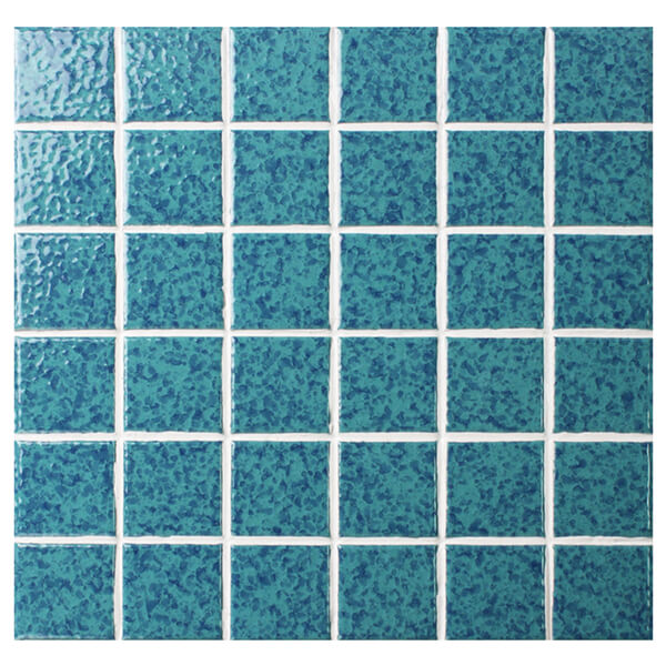cut turquoise pool tile sheet to have chips and decorate pool step.jpg
