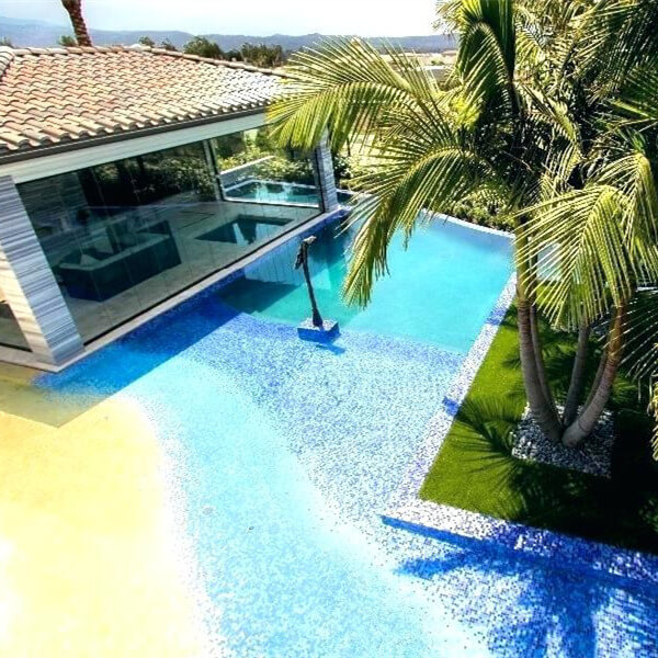 a beach entry pool with multicolor mosaic