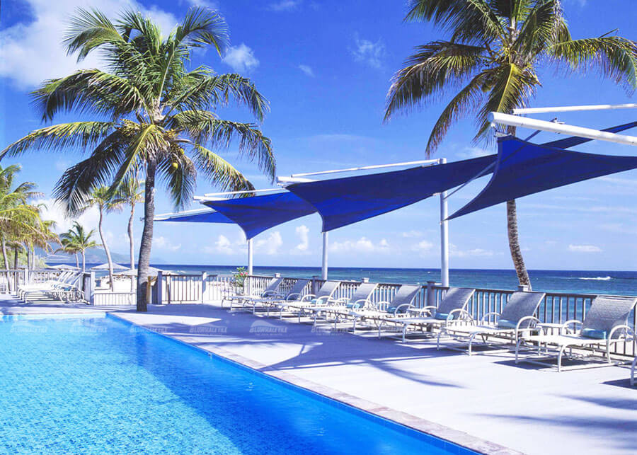 concrete decking combines well with blue swimming pool mosaic tile